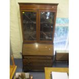 An Edwardian mahogany bureau bookcase having glazed doors above fall flap and drawers 79 1/2"h x