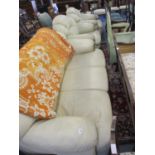 A Wyvern cream leather two-seater sofa with two matching armchairs