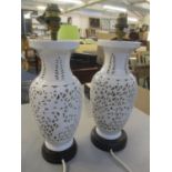 A pair of oriental white glazed and pierced table lamps