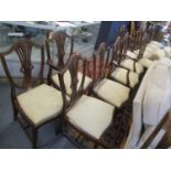 A set of twelve reproduction mahogany, shield back dining chairs with drop in seats