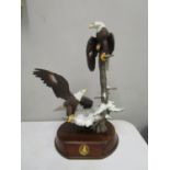 A painted porcelain model of The Alaska Chilkat Bald Eagle preserve by Ted Bldylock on a plinth