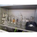 A selection of glassware to include decanters, one with a Mickey Mouse stopper and others