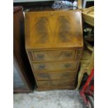 A late 20th century mahogany four drawer bureau