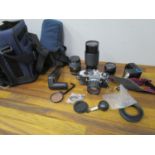 A Pentax ME Super camera, 50mm lens, a Miranda lens, a Vivitar 75-205mm lens and other items