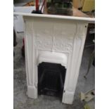 An early 20th century cast iron white painted fireplace 40 1/2" H x 28 1/2" W