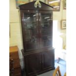 A reproduction mahogany glazed bookcase above cupboard doors 83" x 36" x 13"