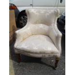 An early 20th century upholstered armchair on satinwood, square tapered legs