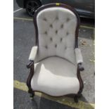 A Victorian walnut framed, upholstered armchair on cabriole legs