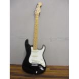 A Fender Stratocaster electric guitar in black and white, serial number T036123, made in Japan