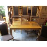 A modern oak extending dining table with two additional leaves, 29" h x 59" w, on square legs and