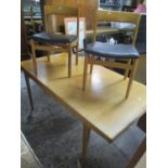 A mid 20th century teak extending dining table 29"h x 69"w, together with six chairs