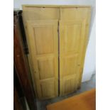 A modern oak wardrobe with twin panelled doors