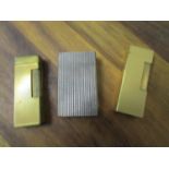 Two Dunhill gold plated lighters and a Dupont lighter