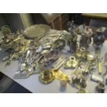 A large selection of silver plate to include loose cutlery, condiments, napkin rings, trays and