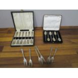 A set of six silver coffee spoons and two sets of six silver plated cake forks