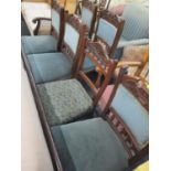 A set of six late Victorian walnut dining chairs standing on turned legs