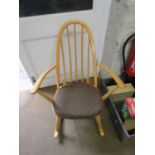 An Ercol beech spindle back rocking armchair