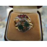 A 585 14k yellow gold ring set with two central, claw set emeralds surrounded by two bands, each