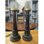 A pair of stained wooden carved table lamps in the form of lighthouses