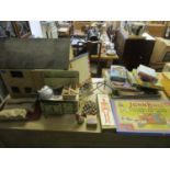 A mixed lot of child's toys and games to include a wooden doll's house and contents, a Mettoy