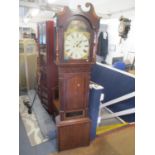 A Georgian oak long case clock having a painted arched top dial and fitted with an 8-day movement 84