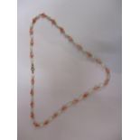 A pearl, coral and gold coloured metal necklace, 16"long