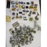 A quantity of mainly transport related enamelled pin badges, together with a white metal model of an