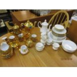 A Royal Winton gold coloured part coffee set and a Royal Stafford white glazed part coffee set and