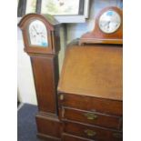 An early 20th century German mahogany cased mantel clock, together with a mahogany cased grandmother