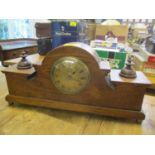 An early 20th century oak mantle clock having a gilt dial and reverse barley twist supports