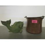 A small copper pot with metal handle and a patinated metal model of a fish