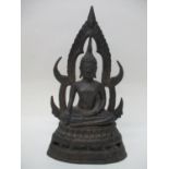 A late 19th/early 20th century Indian cast bronze Buddha sitting under an arbour, on a plinth,