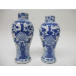 A near pair of 19th/20th century Chinese blue and white vases with tapered, baluster bodies and