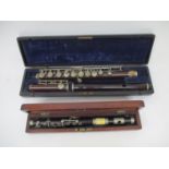 A 1920s A H Langlois rosewood flute with nickel plated keys in three sections cased and an early