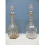 A near pair of 1830's glass decanters with tapered, faceted stoppers, a three ring neck, faceted