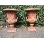 A pair of late 20th century terracotta campana garden urns with a bead, egg and dart rim and twin