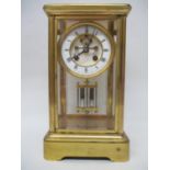 An early 20th century four window large mantle clock with a visual escapement, white enamelled