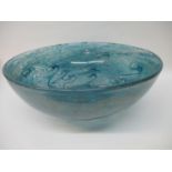 A Monart style glass bowl with a domed centre decorated with blue and white scrolls and flecks, 6"