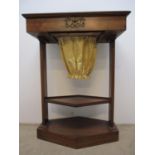 A 19th century Empire style walnut sewing table, the hinged top enclosing a mirror and compartmented