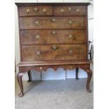 An early 18th century walnut chest on stand with a quarter veneered, feather and crossbanded top,