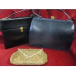 Aspreys of London - a black leather handbag with gilt hardware, together with a Mappin & Webb navy