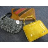 Three 20th century designer bags comprising a yellow Bulaggi box bag with beehive clasp, a black and