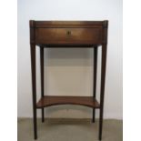 An early 19th century walnut side table with a string inlaid top, over a drawer, on turned,