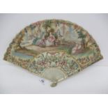 A late 18th century French fan, the paper leaf painted with lovers in the countryside, a female