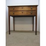 A 19th century French satinwood, planked top side table with two long drawers, on square tapering