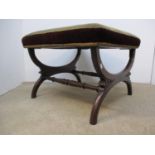 A William IV rosewood stool with an upholstered top, on crossover legs with carved ornament, 16 1/