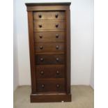 An early 20th century mahogany Wellington chest with seven graduated drawers, turned handles and a