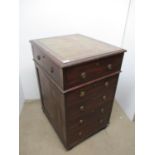 An early Victorian mahogany pedestal with a tooled green leather top over a secretaire drawer