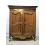 A 19th century French walnut cabinet with a detachable box top, over a pair of shaped, panelled