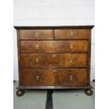 An early 18th century possibly later string inlaid walnut chest of two short and three graduated